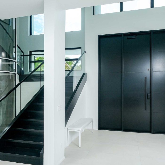 Modern entrance with black stairs and elevator
