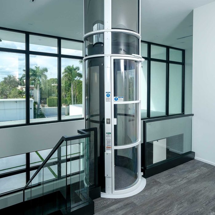 Modern home with glass elevator and large windows