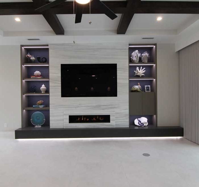 Modern living room with built-in fireplace and shelves.
