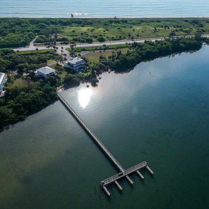 Aerial view of waterfront properties and pier.
