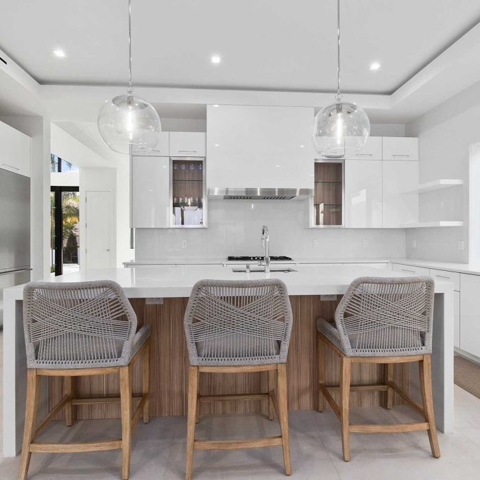 Modern kitchen with island and pendant lights.