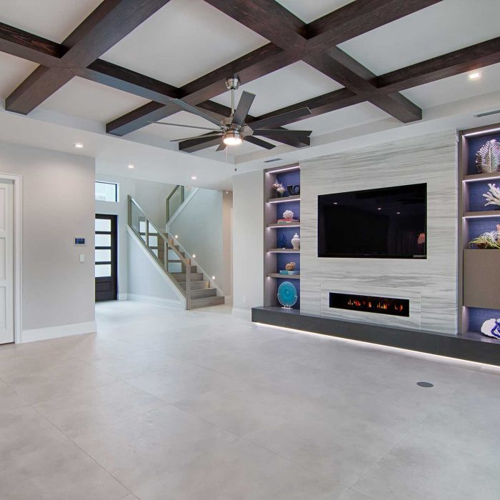 Modern living room with TV and fireplace.