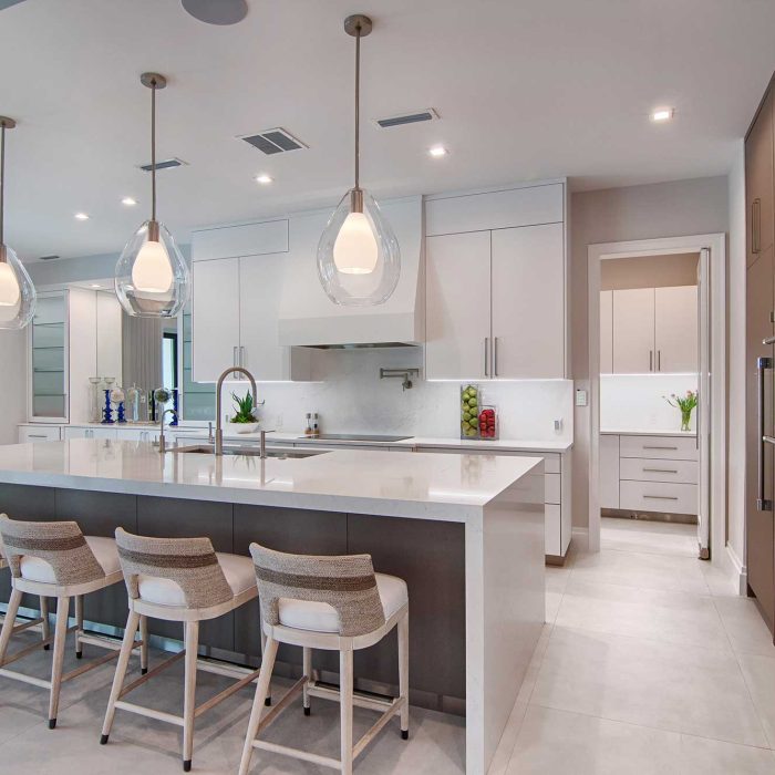 Modern kitchen interior with island and pendant lighting.