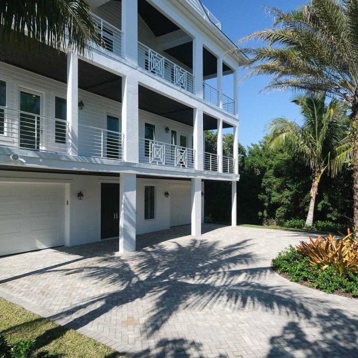 Modern house with palm trees and driveway