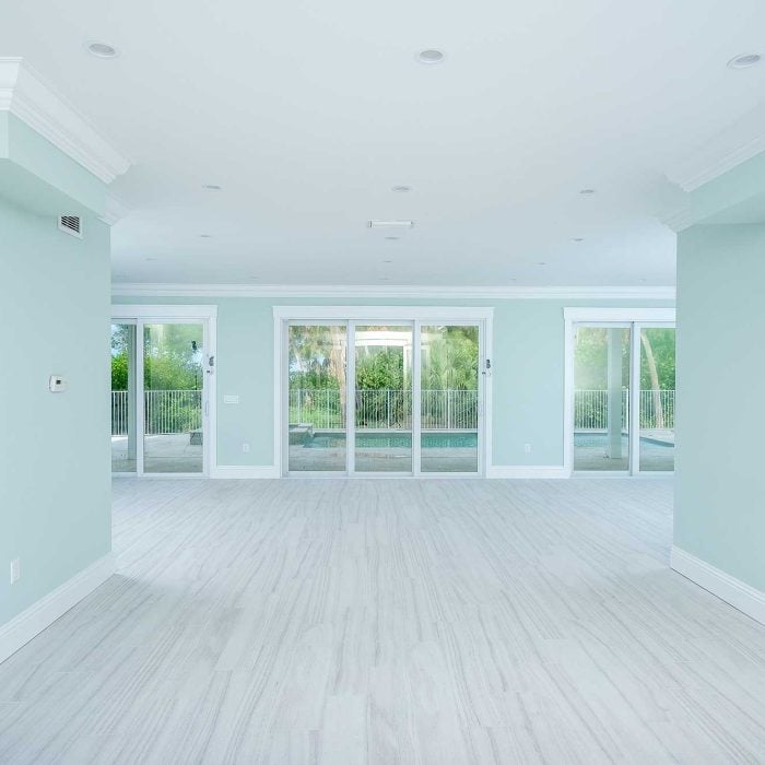 Spacious empty room with large sliding glass doors.