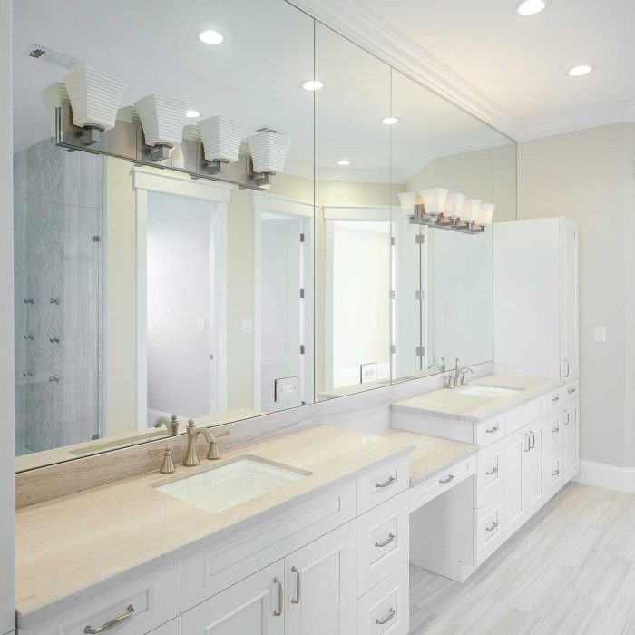 Spacious modern bathroom with double vanity and mirrors.
