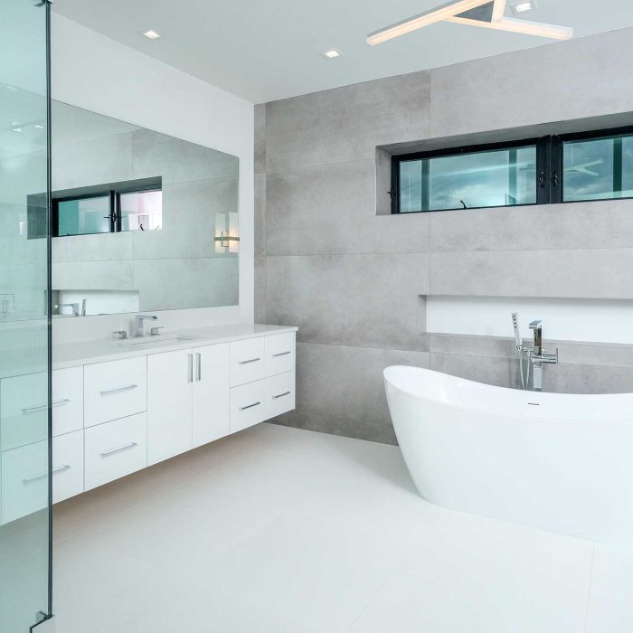 Modern bathroom with freestanding tub and glass shower.