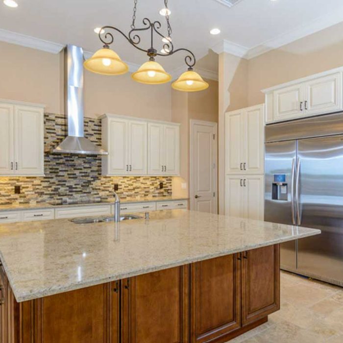 Modern kitchen with island and stainless appliances.