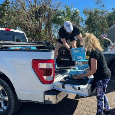 Volunteers loading supplies into a truck bed