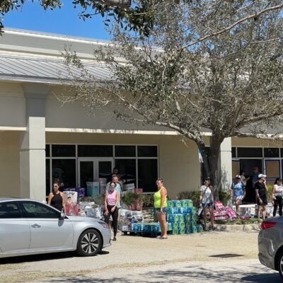 People lining up outside store for supplies