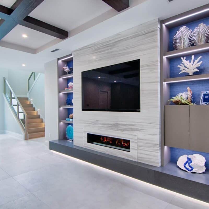 Modern living room with fireplace and display shelves.