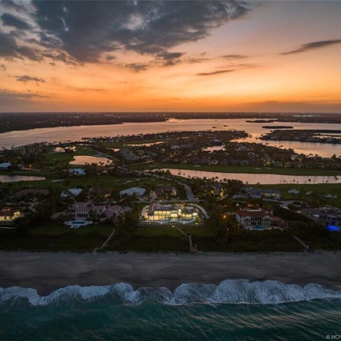 Aerial view of oceanfront homes at sunset.