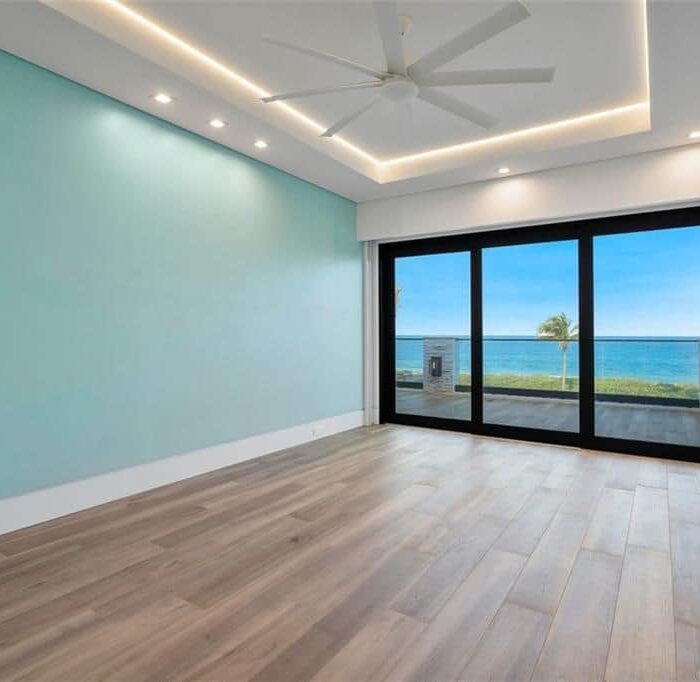 Modern room with ocean view and sliding doors.