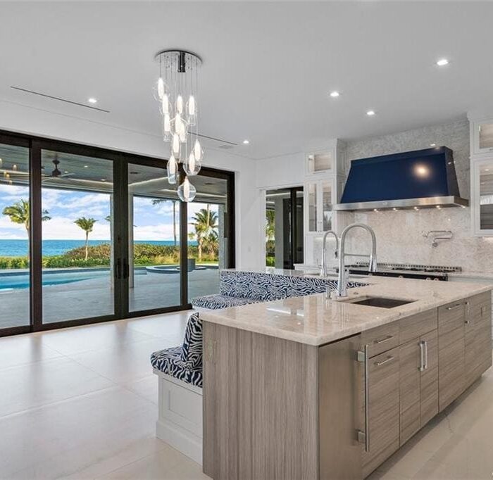 Modern kitchen with ocean view and island sink.