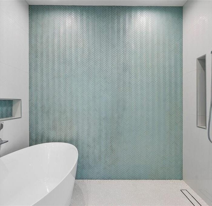 Modern bathroom with freestanding tub and glass shower.