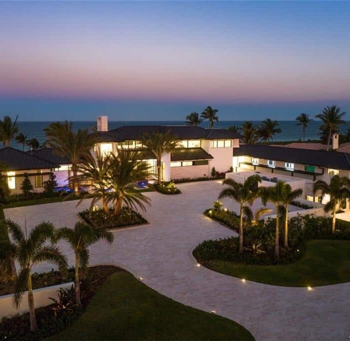 Luxurious beachfront house at sunset.