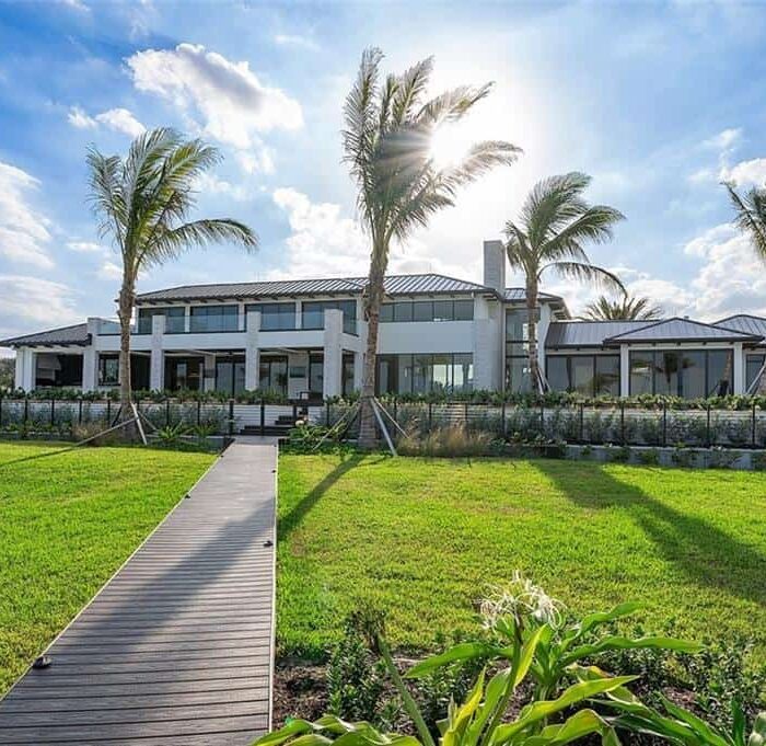 Modern house with palm trees and garden view.