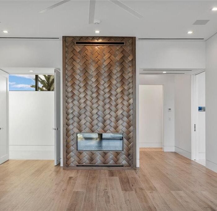 Modern room with decorative partition and fireplace.