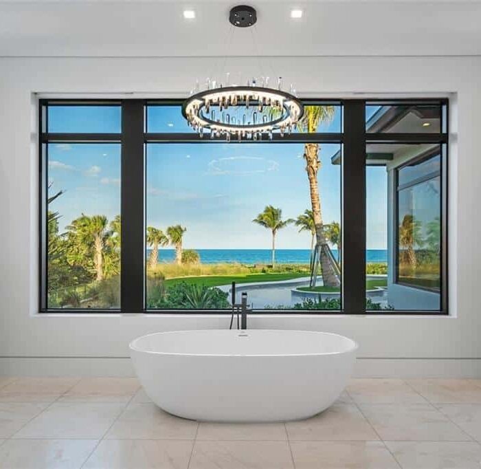 Luxurious bathroom with ocean view and chandelier.