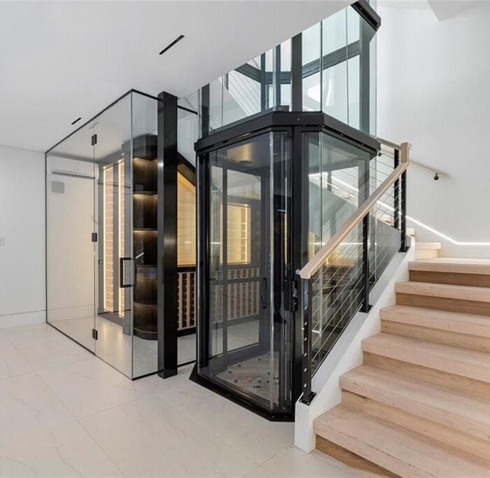 Modern home staircase with glass elevator