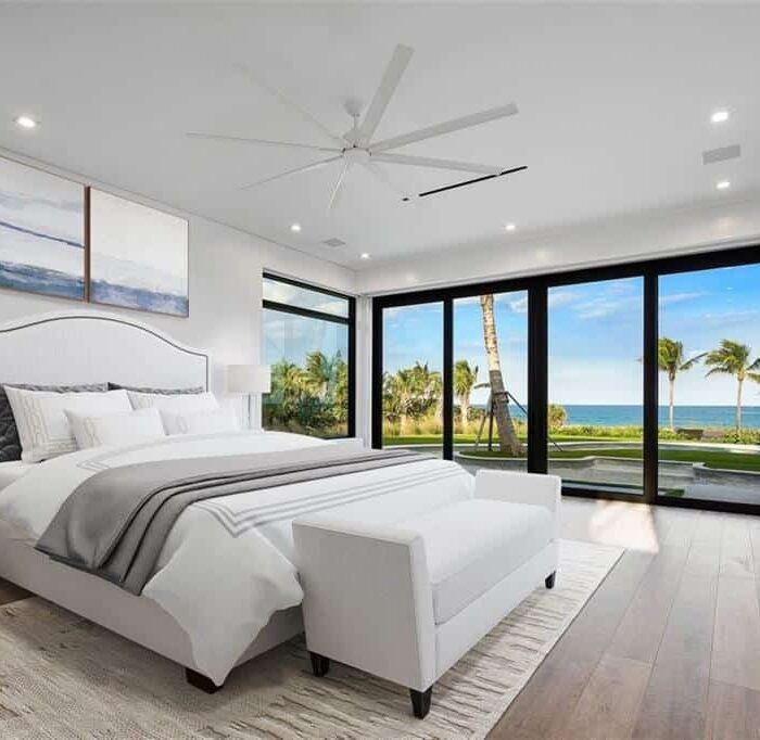 Luxury bedroom with ocean view and modern decor.