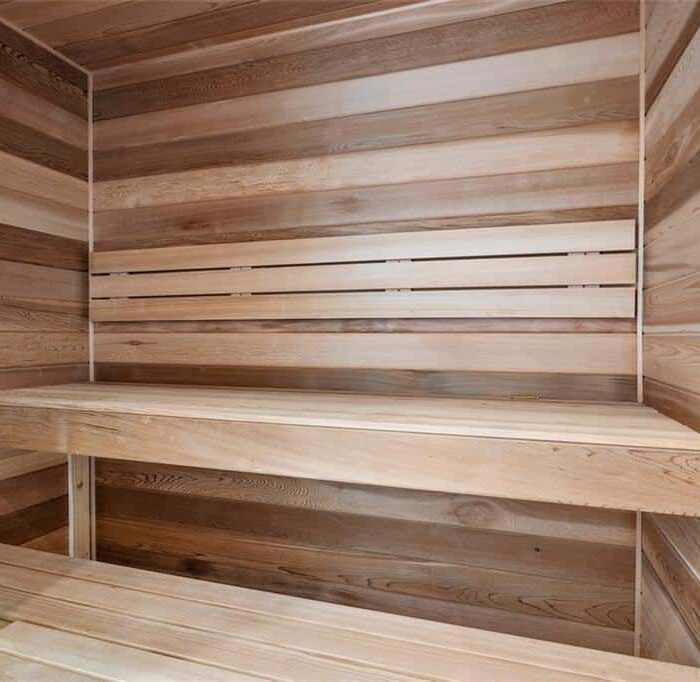 Wooden interior of a sauna with benches.