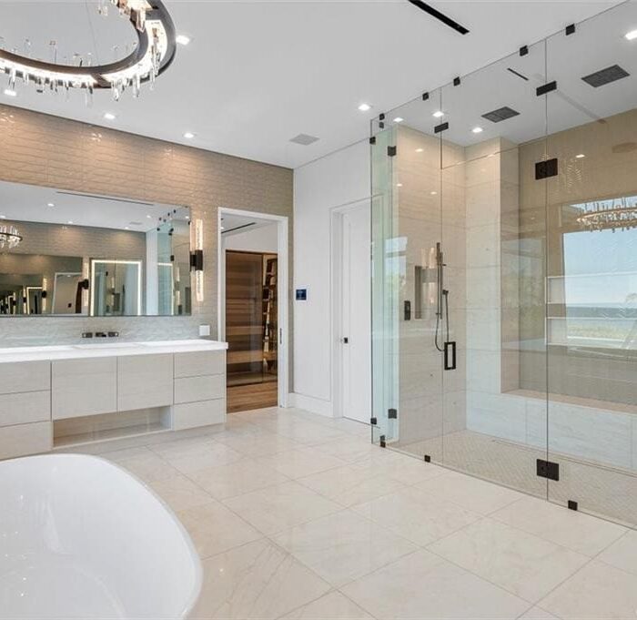 Luxurious modern bathroom with glass shower enclosure.