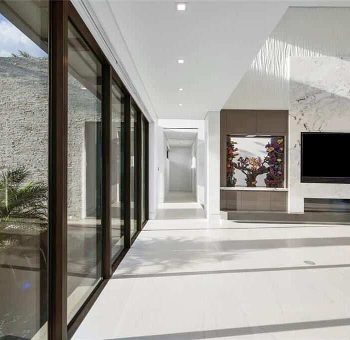 Modern living room with marble and glass features.