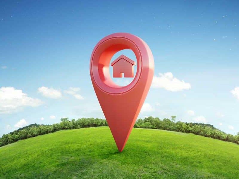House icon in 3D location pin on grass