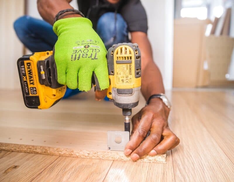 Person assembling furniture with power drill