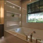 Modern bathroom with a large bathtub and window.