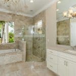 Modern bathroom with glass shower and bathtub.