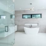 Modern bathroom with glass shower and freestanding tub.