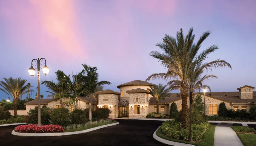 Elegant villa with palm trees at sunset.