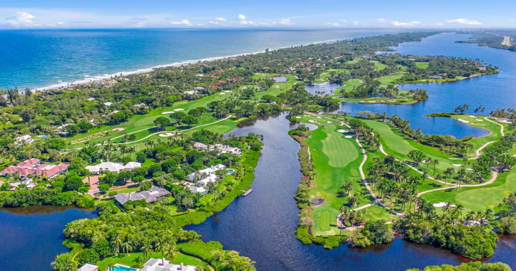 Aerial view of golf course by the ocean.