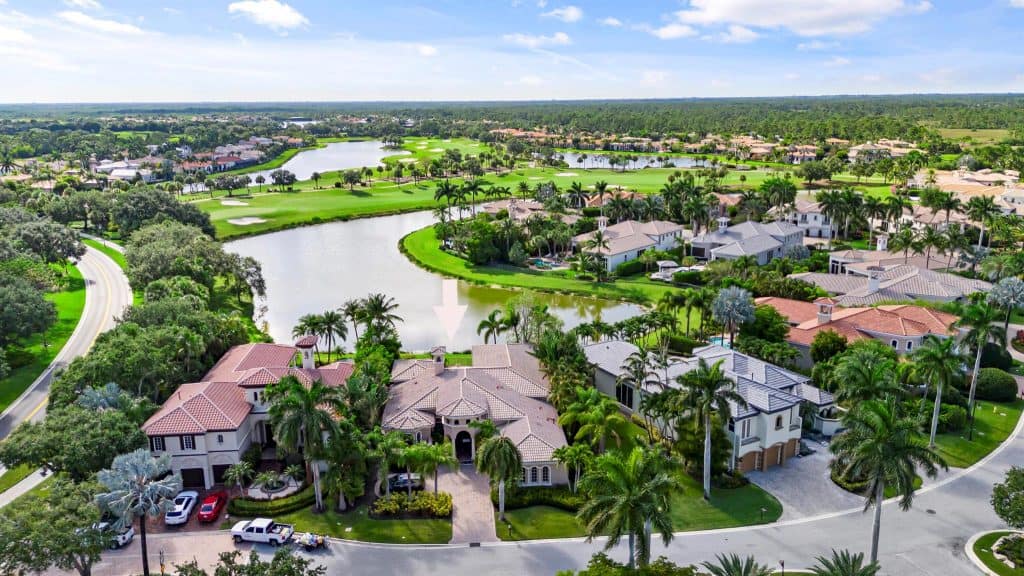 Aerial view of luxury homes by a golf course.