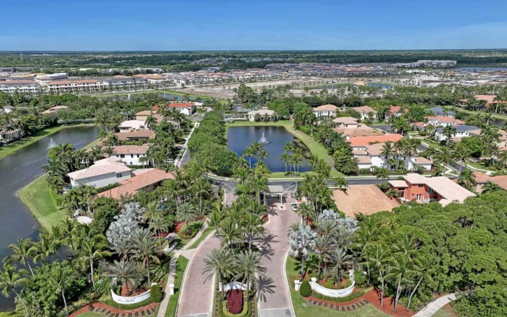 Aerial view of tropical residential neighborhood with water feature.