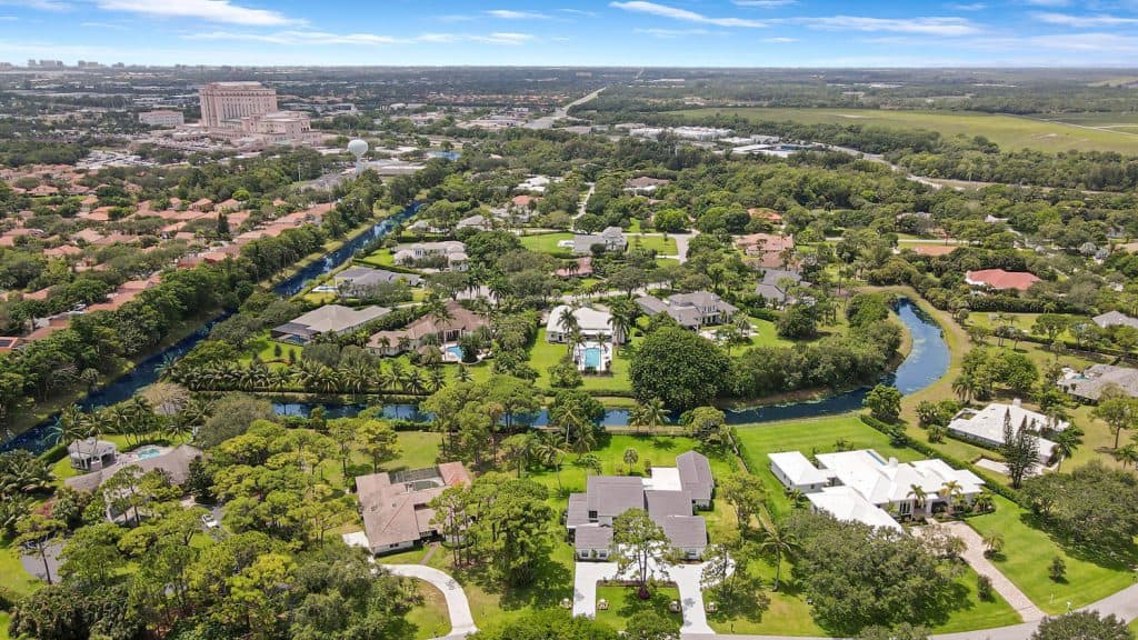 Aerial view of suburban homes and lush greenery.