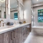 Modern bathroom with double sink and large mirrors.