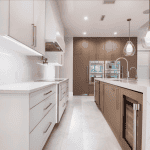Modern kitchen with white countertops and brown cabinets.