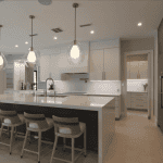 Modern kitchen with island and pendant lights.