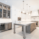 Modern kitchen with white cabinets and island counter.