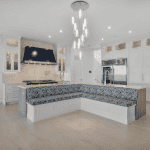 Modern kitchen with island and unique seating area.