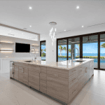 Modern kitchen with ocean view and island sink.