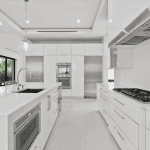 Modern white kitchen with stainless steel appliances