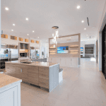 Modern open-concept kitchen with island and sliding doors.