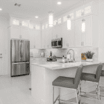 Modern white kitchen with island and pendant lights