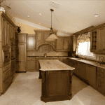 Spacious, elegant kitchen with wooden cabinets and island.