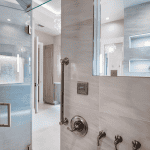 Modern bathroom with glass shower and fixtures.