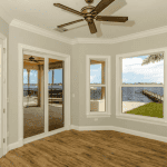 Bright room with waterfront view and wooden flooring.